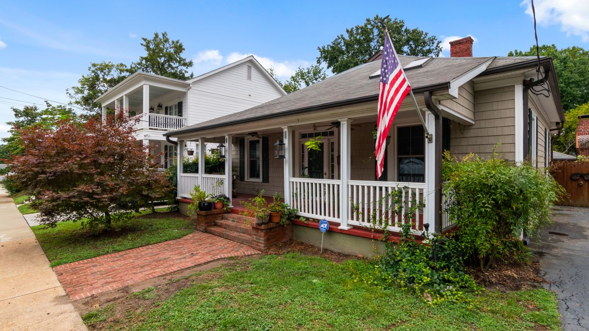 Clapboard bungalow with a deep front porch, the housing type across Savannah's midtown streets