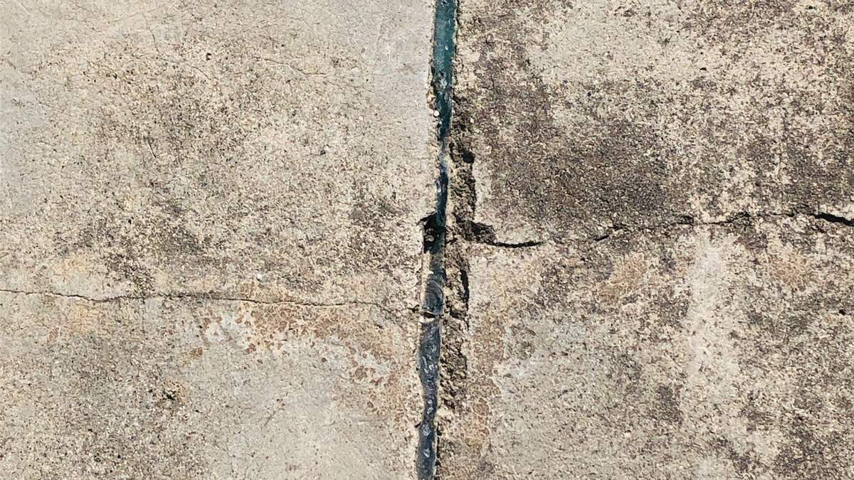 Concrete slab sections separated and dropped at the joint