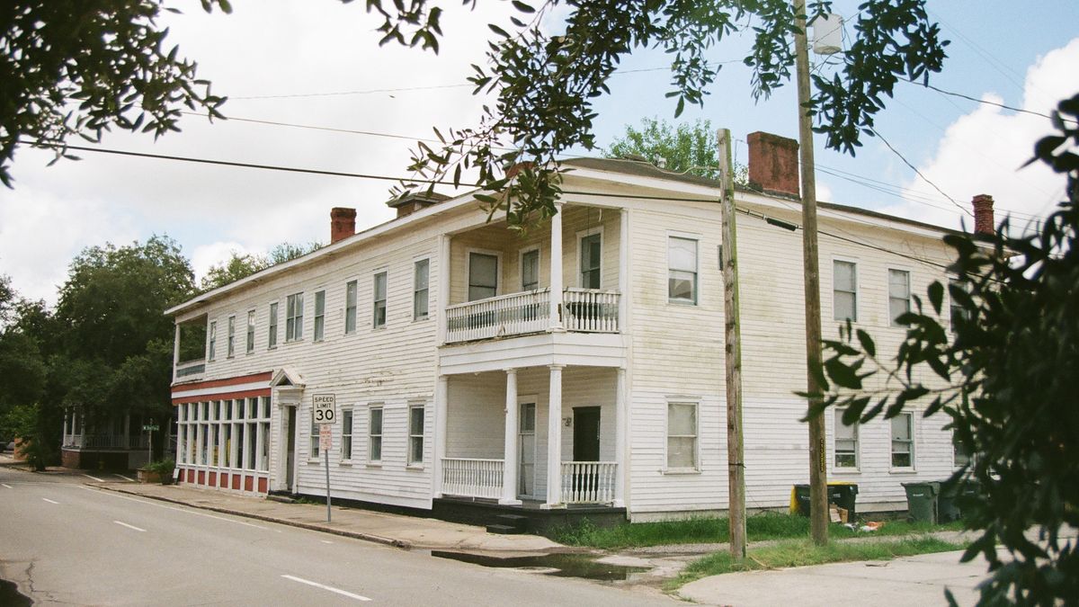 Old white timber building on a small-town street corner